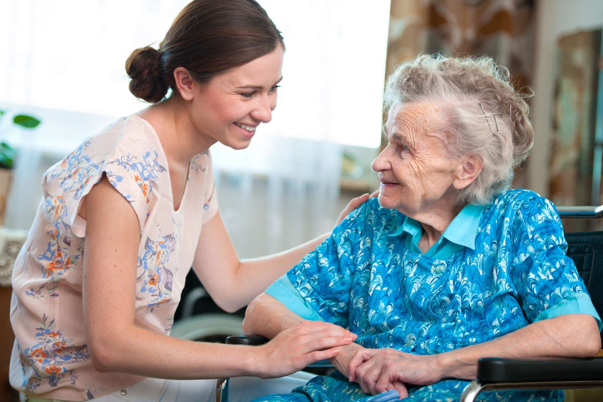 Senior woman with her caregiver. An important aspect of senior care is bathing help for seniors.