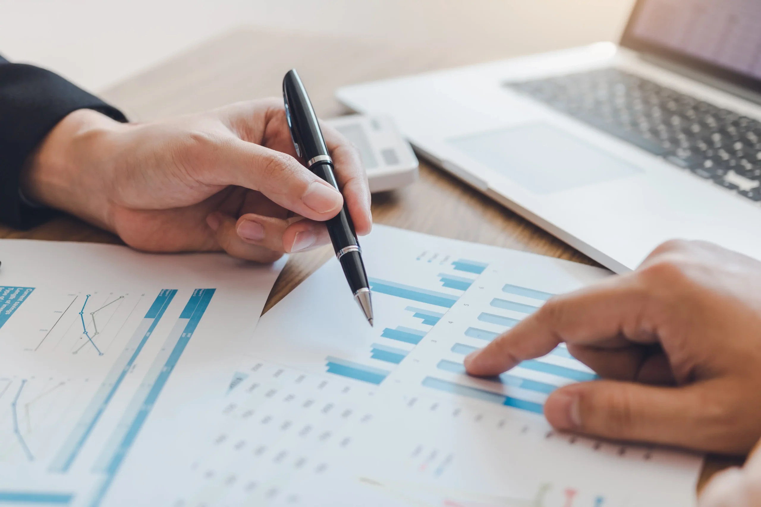 Hands going over financial documents and charts; Apollo Bath financing and leasing options make ADA-compliant walk-in tubs affordable for all budgets