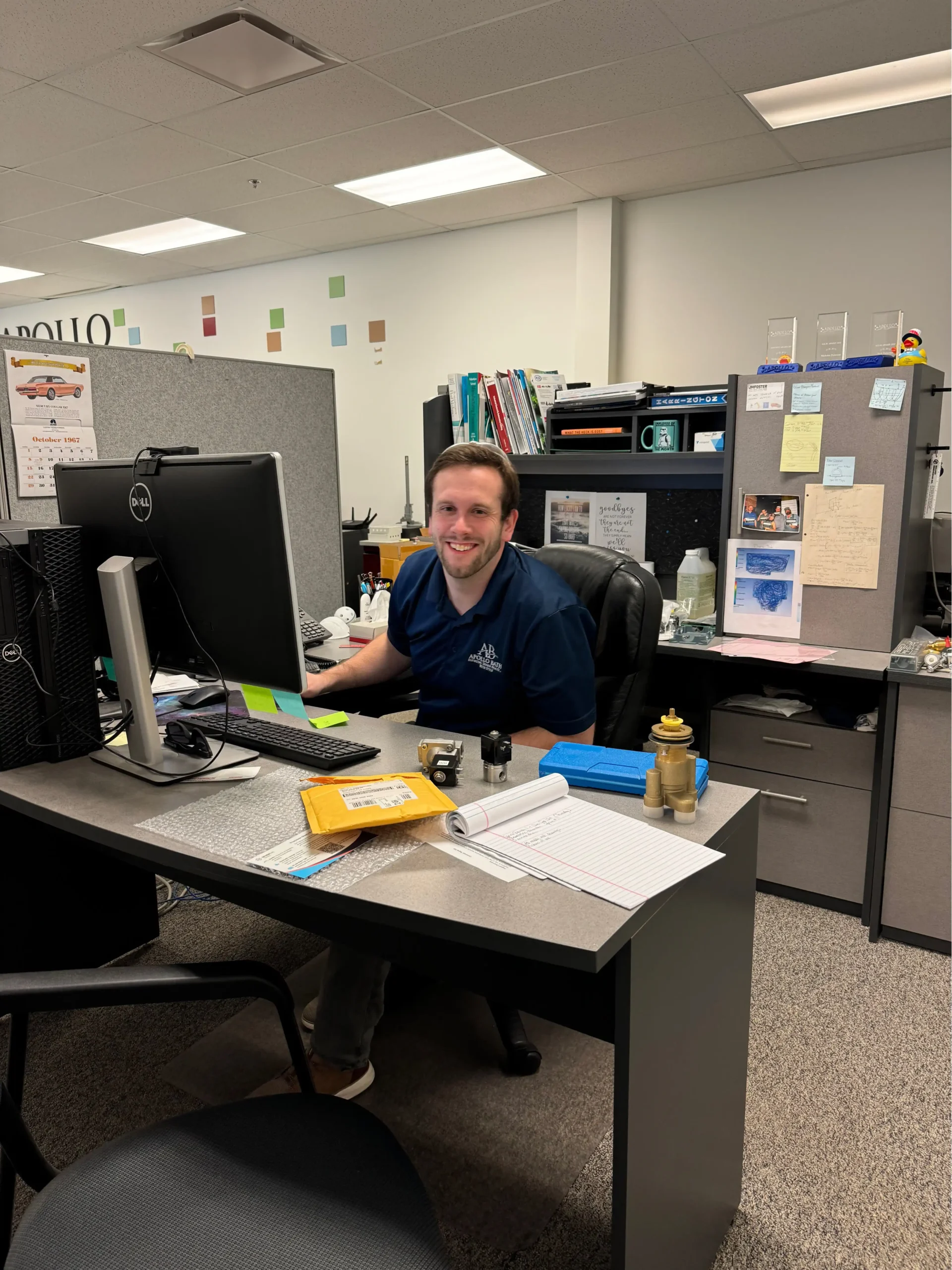 Our Team 2 Apollo Bath employee working at their desk, ensuring top-quality hydrotherapy tubs and elderly bathtub solutions